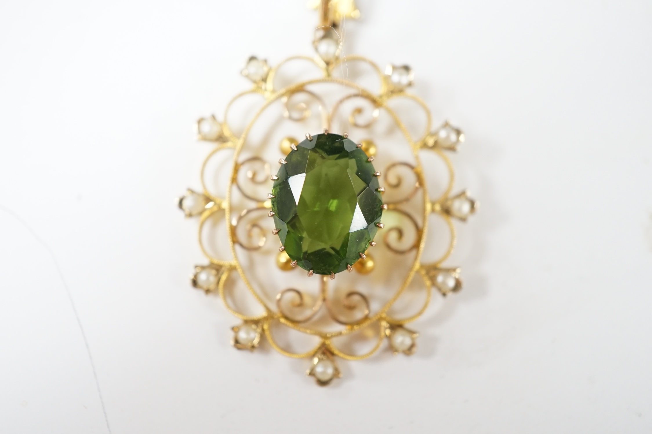 An early 20th century style 9ct, green paste and seed pearl set oval open work pendant, 38mm, 3.5 grams. Condition - good